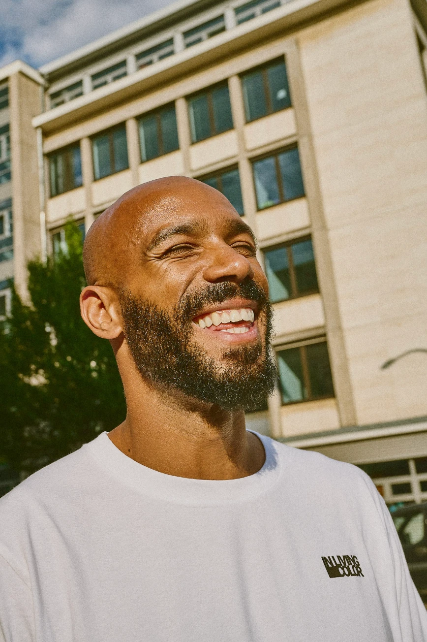 Ben Olayinka laughing outside in Berlin