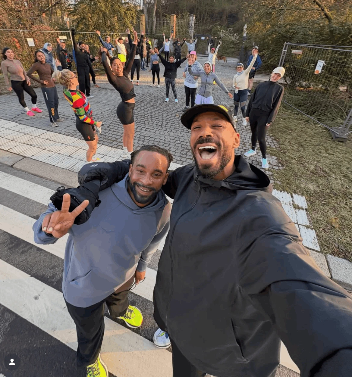 Ben Olayinka taking a selfie with runners from his community