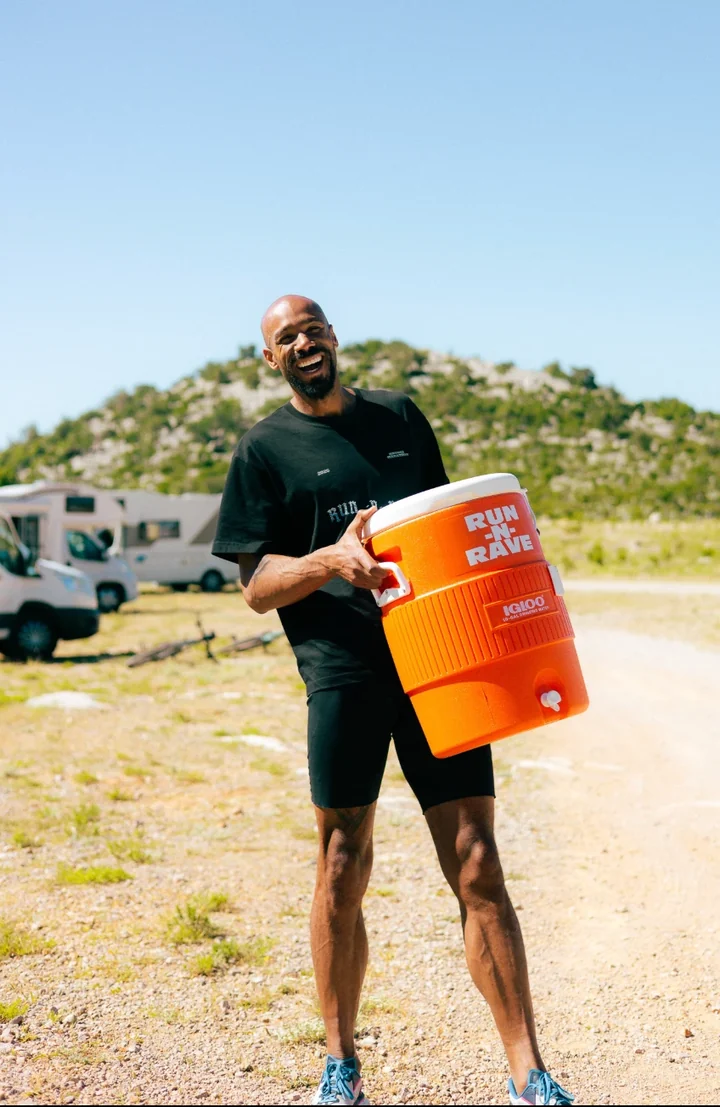 Ben holding a RUN-N-RAVE cooler at an outdoor event